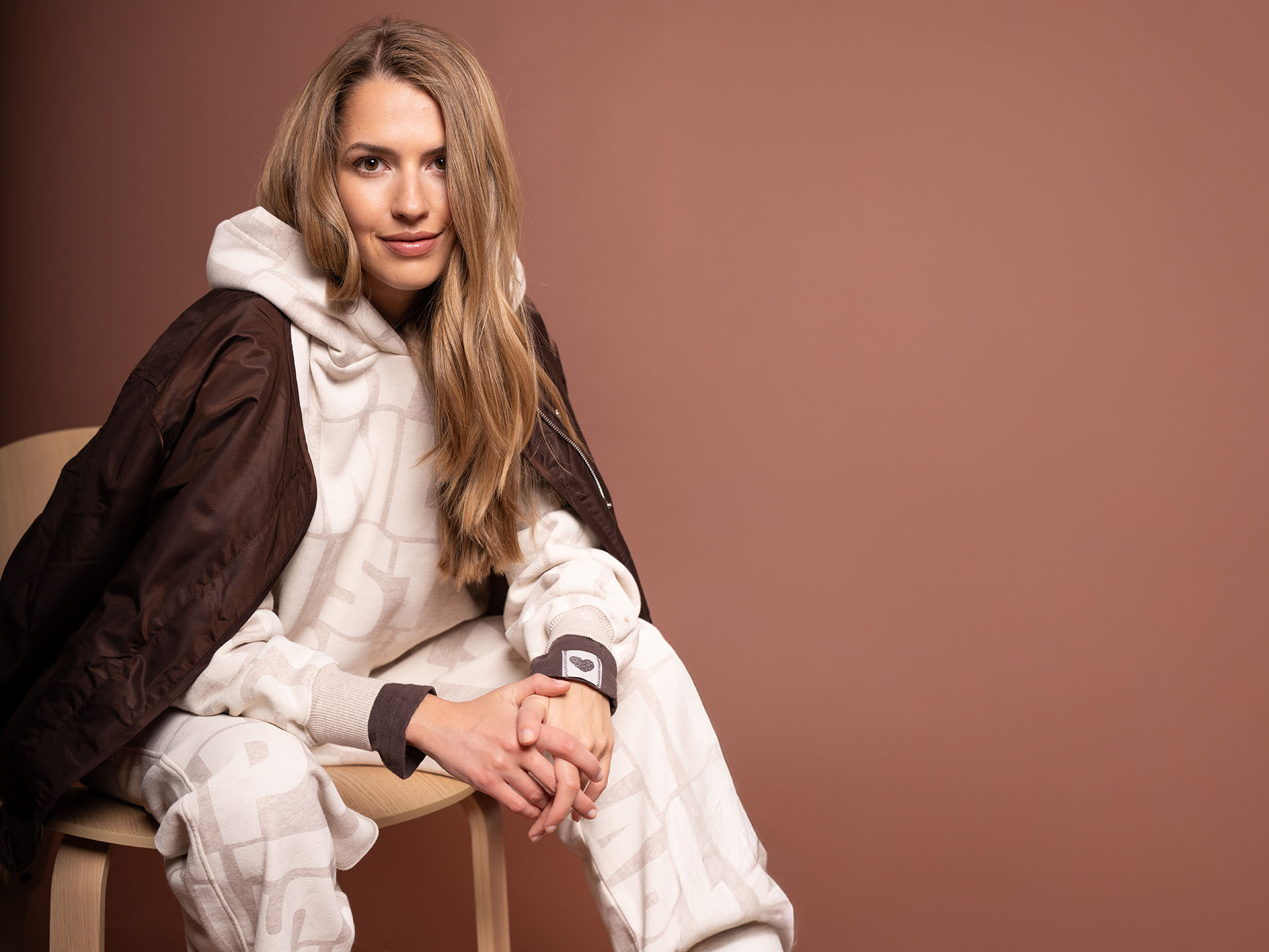 Woman with brown jacket and hoodie